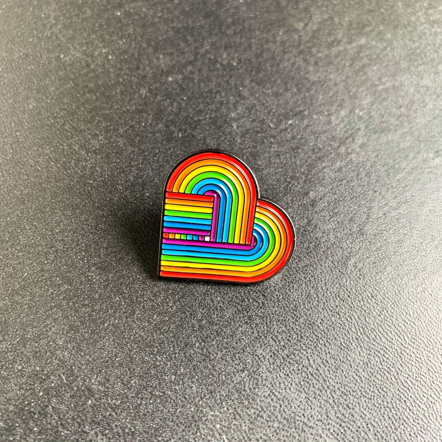 Pride enamel pin featuring a rainbow heart on a soft enamel finish.
LGBTQ+ rainbow pin with vibrant colors and a retro-inspired design.
Close-up of a high-quality LGBTQ enamel pin on a denim jacket.
LGBTQ Pride badge with a heart-shaped rainbow design, perfect for bags or accessories.
Soft enamel pride pin with a secure backing, ideal for showing LGBTQ+ support.