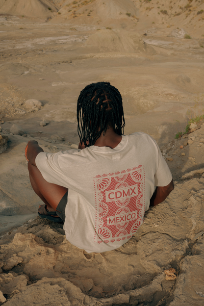 Back view of Unisex White Crewneck T-Shirt featuring red Papel Picado CDMX Mexico design worn by a man