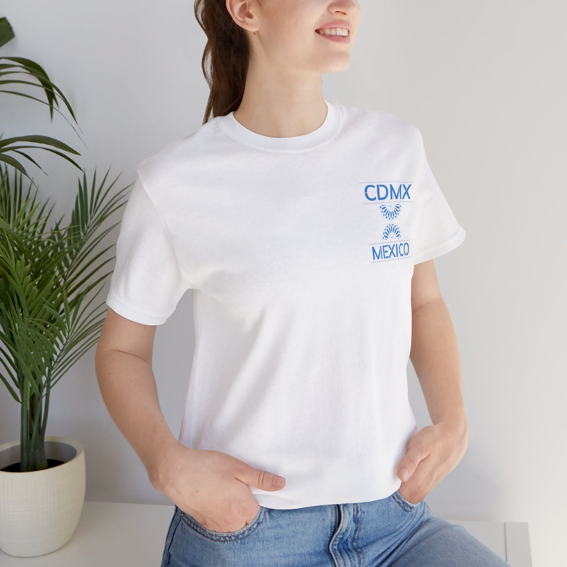 Front view of Unisex White Crewneck T-Shirt featuring blue Papel Picado CDMX Mexico design on woman model
